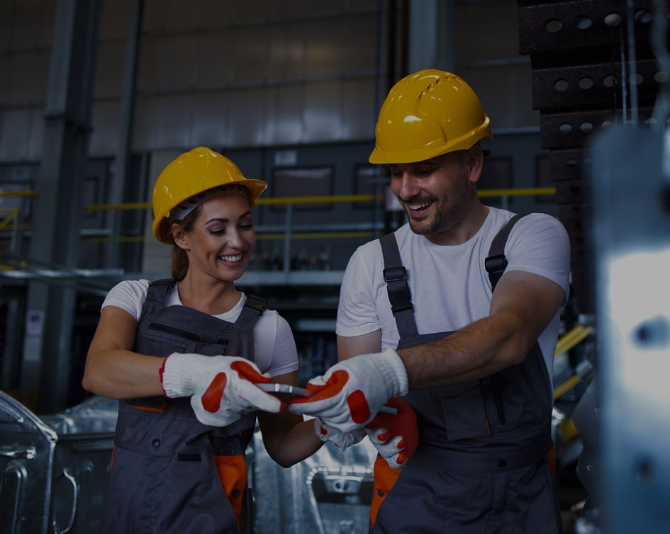 Factory workers reviewing a component